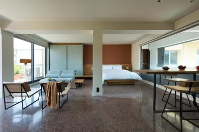 a bedroom with a bed and a table and chairs at Acropolis View Luxury Apartment in Athens