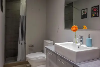 a bathroom with a sink and a toilet and a shower at Athens Suites in Athens