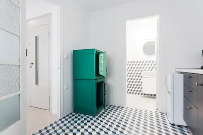 a green refrigerator in a kitchen with a checkered floor at Karitsi Place in Athens