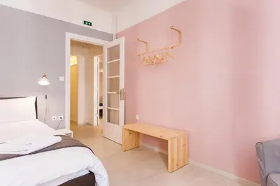 a bedroom with a bed and a wooden table at Karitsi Place in Athens