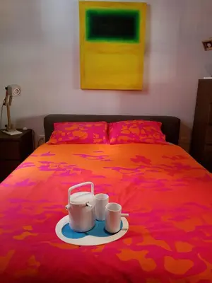 a bed with two cups on a plate on it at Kolonaki Deco Apartment in Athens