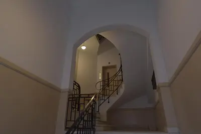 an archway leading up to a stairway with a spiral staircase at Kolonaki Deco Apartment in Athens
