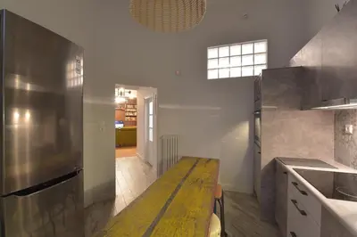 a large kitchen with a wooden table in it at Kolonaki Deco Apartment in Athens