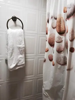 a bathroom with a shower curtain with donuts on it at Gallery Basement in Villa Vravrona in Markopoulo