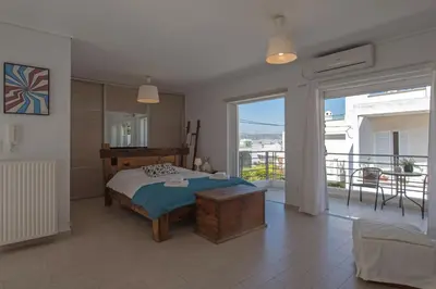 a bedroom with a bed and a balcony at Townhouse in the Historical Centrer of Athens in Athens