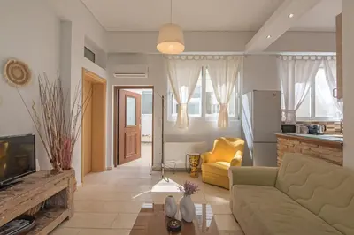 a living room with a couch and a fireplace at Townhouse in the Historical Centrer of Athens in Athens