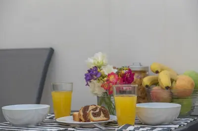 a table with a plate of bread and two glasses of orange juice at Townhouse in the Historical Centrer of Athens in Athens