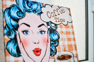 a picture of a woman with a cup of coffee at Lofos Apartment in Athens