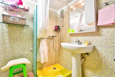 a bathroom with a sink and a shower at Lofos Apartment in Athens