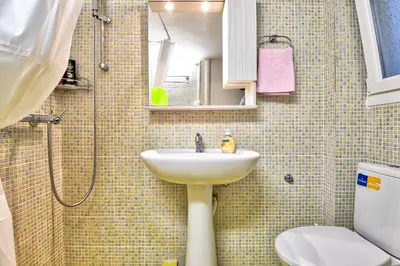 a bathroom with a sink and a shower and a toilet at Lofos Apartment in Athens