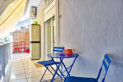 a small table and chairs on a balcony at Lofos Apartment in Athens