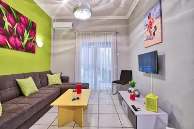 a living room with a couch and a tv at Lofos Apartment in Athens