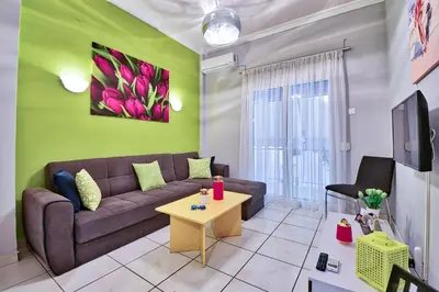 a living room with a couch and a table at Lofos Apartment in Athens