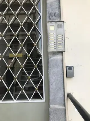 a door with a metal grill on the side of a building at Lofos Apartment in Athens