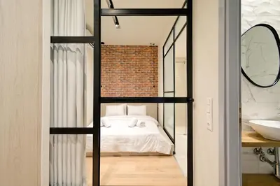 a bedroom with a bed in a room with a mirror at Muses Residence in Athens