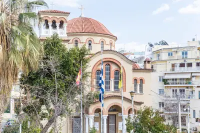 a building with a flag in front of it at Muses Residence in Athens