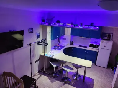 a purple room with a desk and a kitchen with purple lighting at Cosy apartment Acropolis Point-3 in Athens