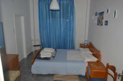 a bedroom with a bed with a blue curtain at Cosy apartment Acropolis Point 2 in Athens