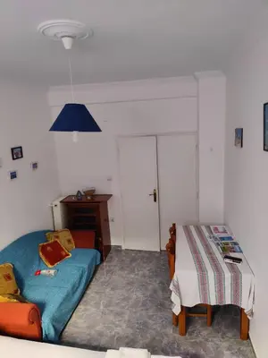 a bedroom with a bed and a table in it at Cosy apartment Acropolis Point 2 in Athens