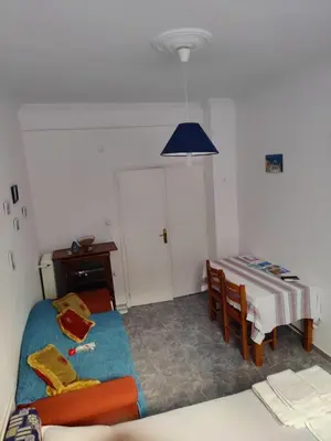 a living room with a bed and a table at Cosy apartment Acropolis Point 2 in Athens