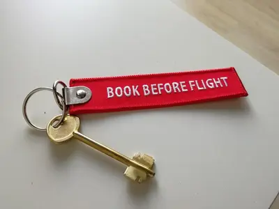 a red book before flight tag with a key at Cosy apartment Acropolis Point 2 in Athens