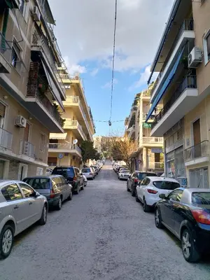a street lined with parked cars in a city at Cosy apartment Acropolis Point 2 in Athens