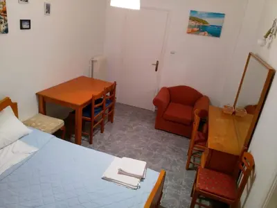 a bedroom with a bed and a table and a chair at Cosy apartment Acropolis Point 2 in Athens