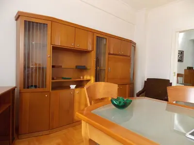 a kitchen with wooden cabinets and a counter top at Pasalimani Long Beach in Piraeus