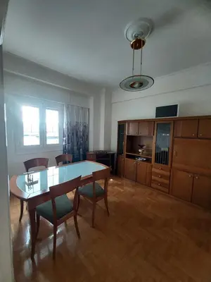 a kitchen with a table and chairs in a room at Pasalimani Long Beach in Piraeus