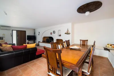 a living room with a table and a couch at Villa Saronida in Saronida