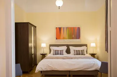 a bedroom with a large bed with two pillows at Acropolis Neoclassical Mansion by YHA in Athens