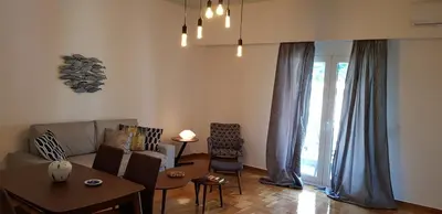 a living room with a couch and a table at Apartment at Acropolis Museum by YHA in Athens