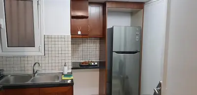 a kitchen with a stainless steel refrigerator and a sink at Apartment at Acropolis Museum by YHA in Athens