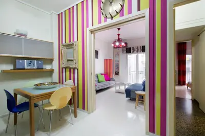 a living room with a table and a dining room at Apartment at Acropolis Museum by YHA in Athens