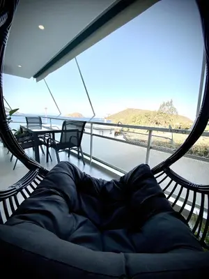 a hammock on a boat with a view of the ocean at Seafront Apartment by C2C Architects in Kalívia Thorikoú