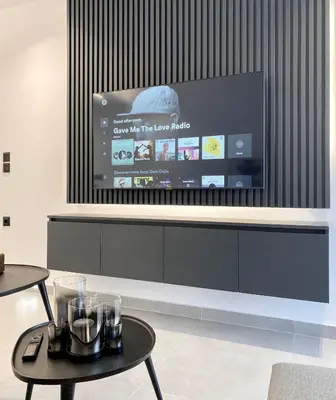 a living room with a flat screen tv on a wall at Seafront Apartment by C2C Architects in Kalívia Thorikoú