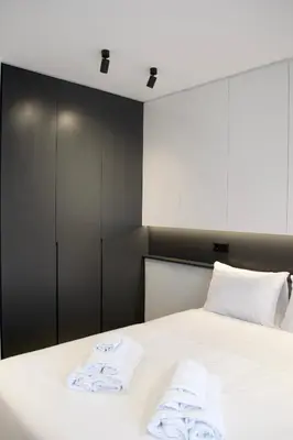 a bedroom with a bed with towels on it at Seafront Apartment by C2C Architects in Kalívia Thorikoú