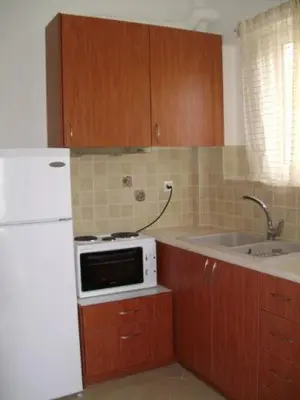 a kitchen with a white refrigerator and a microwave at Villa Alexandra in Agia Marina Aegina