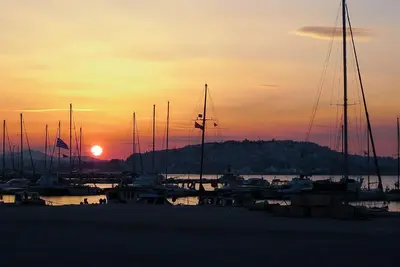 a group of boats docked in a marina at sunset at Kalypso Apartment in Athens