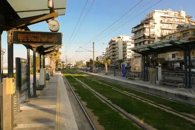 a train station with a train tracks and buildings at Kalypso Apartment in Athens