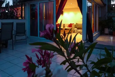 a house with a porch with a plant in the foreground at Kalypso Apartment in Athens