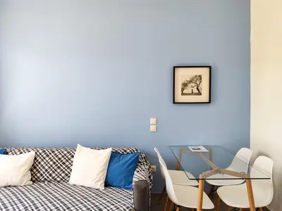 a living room with a couch and a table at KYMA Apartments - Athens Acropolis 7 in Athens