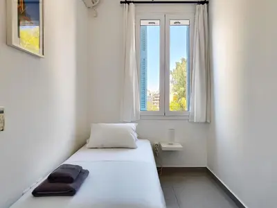 a white bedroom with a bed and a window at KYMA Apartments - Athens Acropolis 7 in Athens