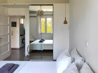 a bedroom with a bed and a mirror at KYMA Apartments - Athens Acropolis 7 in Athens
