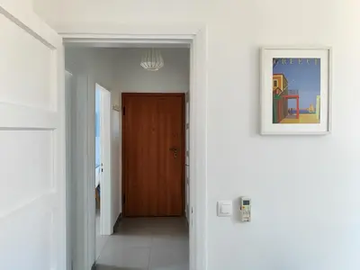 a hallway with a door and a picture on the wall at KYMA Apartments - Athens Acropolis 7 in Athens