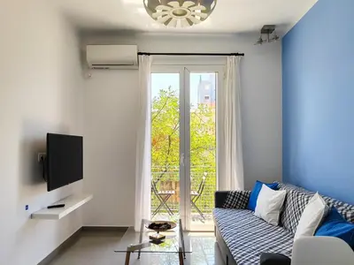 a living room with a couch and a tv at KYMA Apartments - Athens Acropolis 7 in Athens