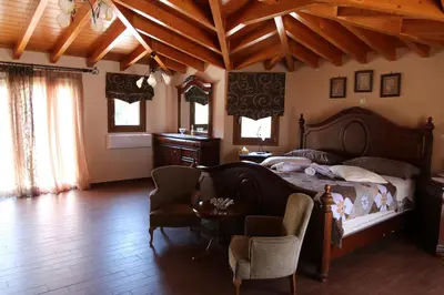 a bedroom with a bed and a table and chairs at Villa Ariadne in Athens