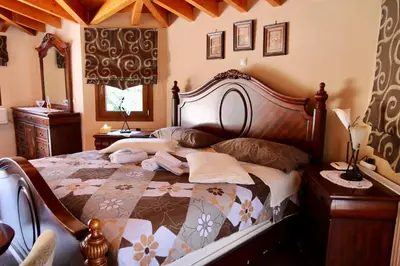 a bedroom with a large wooden bed in a room at Villa Ariadne in Athens