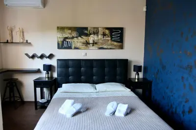 a bedroom with a bed with two towels on it at Villa Ariadne in Athens