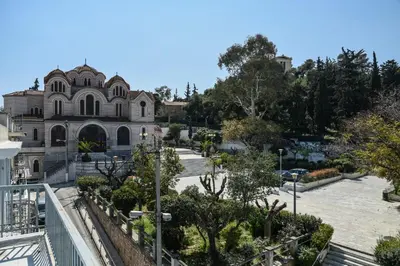 an old building with trees in front of it at Miranda's Apartment in Thissio in Athens